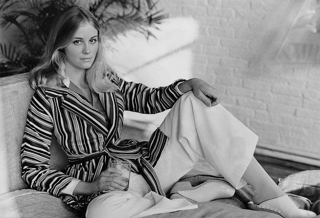 Cybill Shepherd in striped corduroy jacket wrapped and belted over white corduroy pants, 1973.