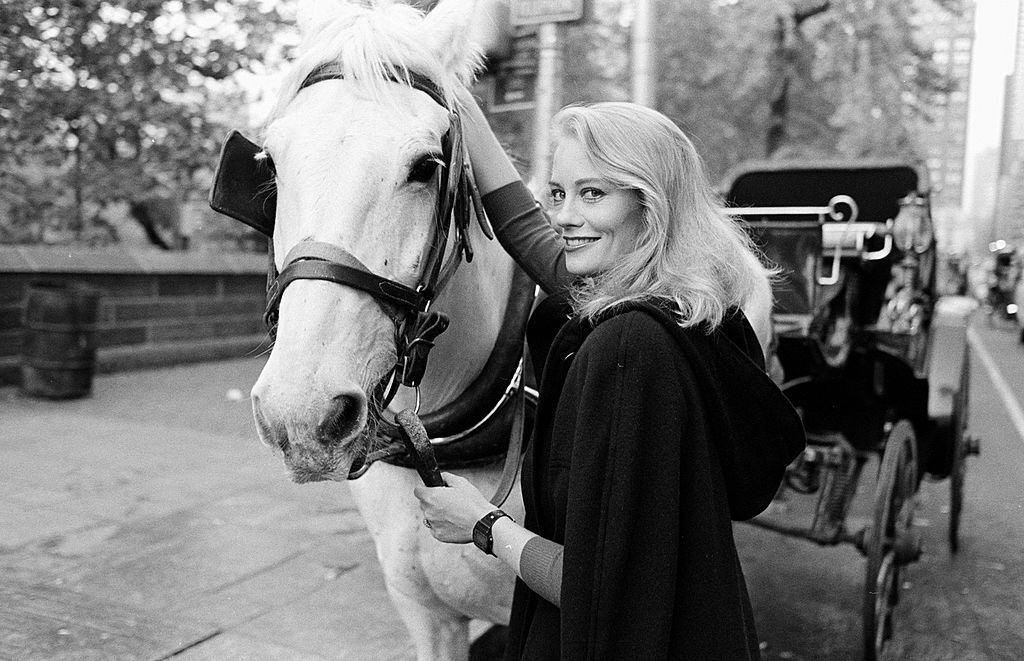 Cybill Shepherd posing with a horse, 1983.