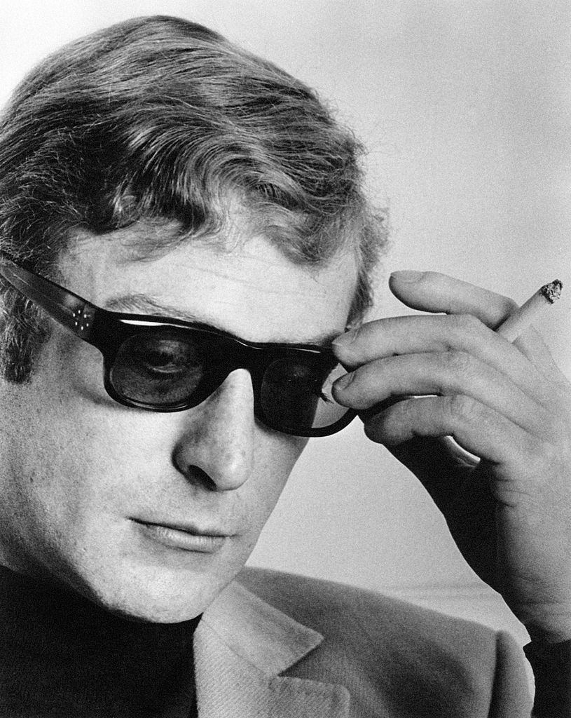 Micheal Caine with a cigarette in his hand during an interview, 1964.