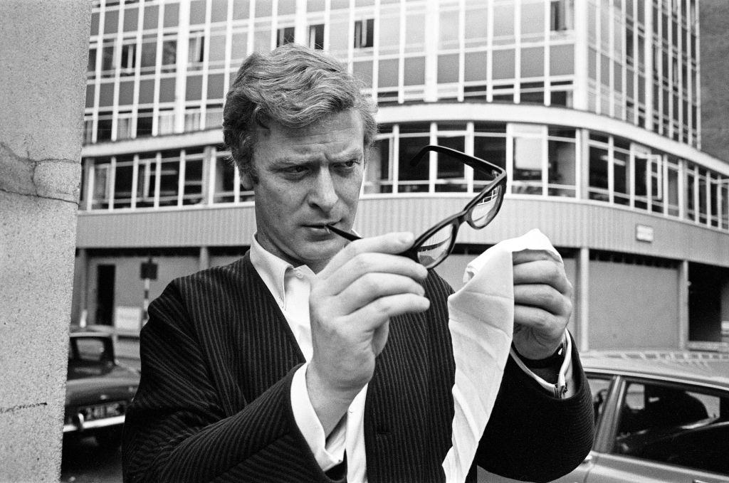 Michael Caine cleaning his glasses, 1964.
