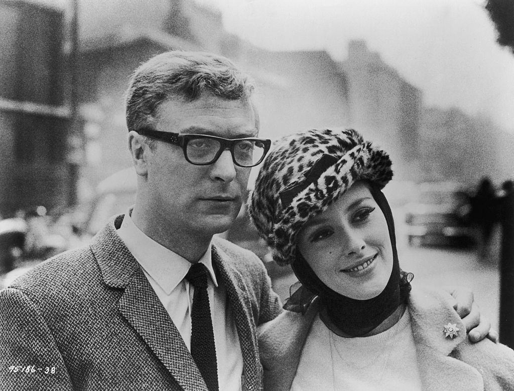 Michael Caine poses with his co-star Sue Lloyd during a break in the location filming of 'The Ipcress File' in London, 1965.