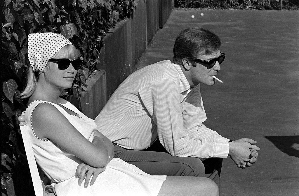 Michael Caine beside an unknown woman, 1966.