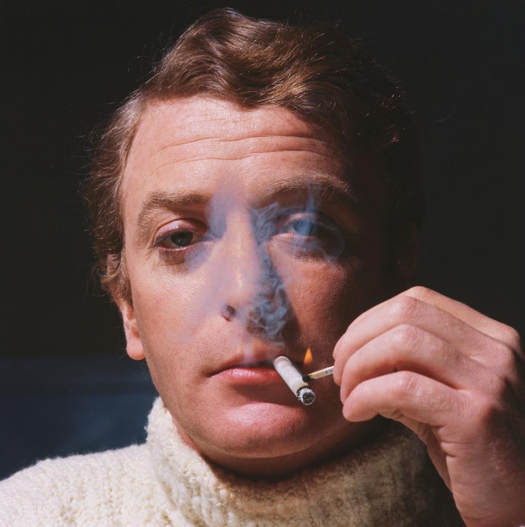 Michael Caine lights a cigarette, 1967.