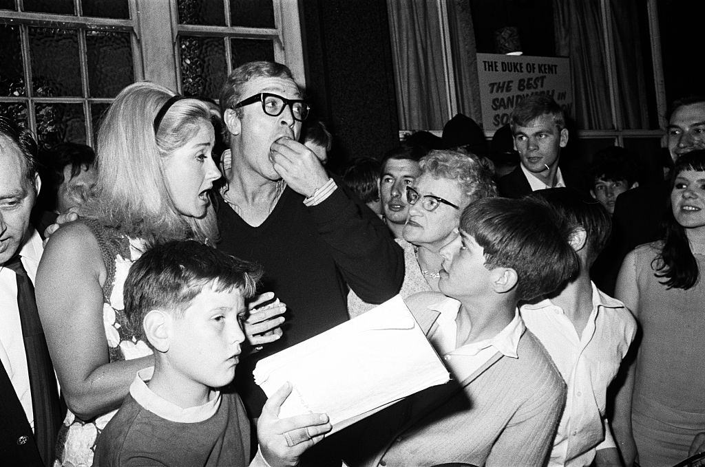 Michael Cain with Lynda Bird Johnson, daughter of the US President, at a party in a pub, 1967.