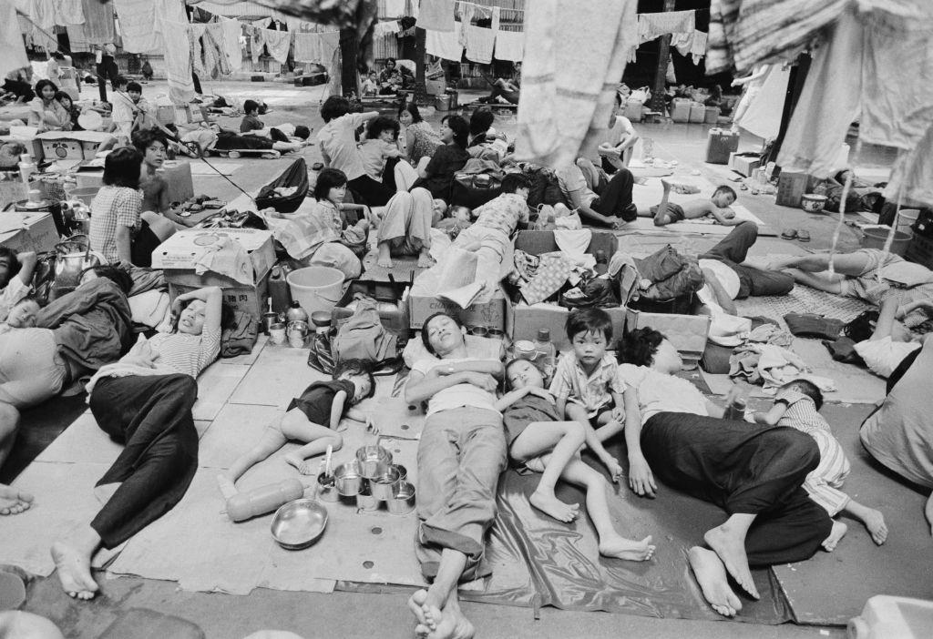 People resting in a refugee shelter at the Government Dock yard in Hong Kong, after leaving Vietnam, 7th January 1980.