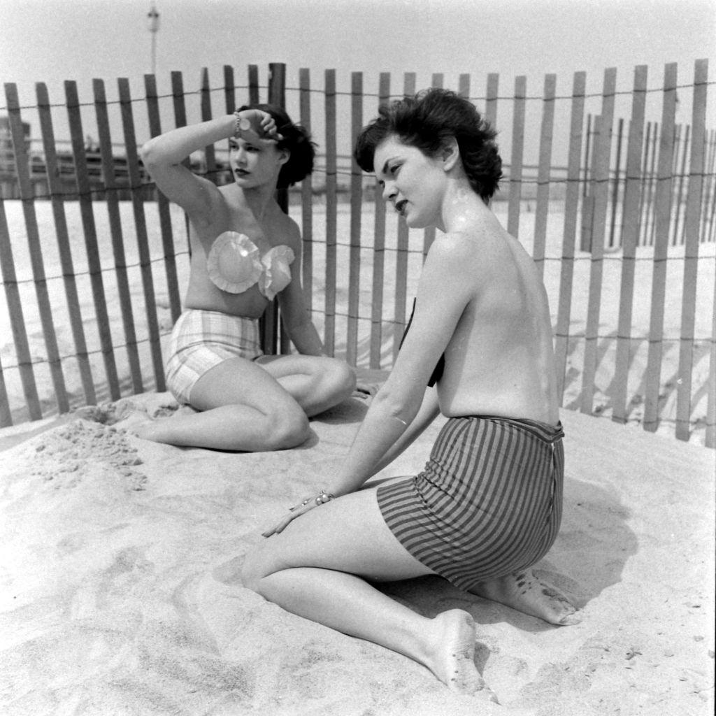 Models wearing the adhesive bra on the beach, 1949.