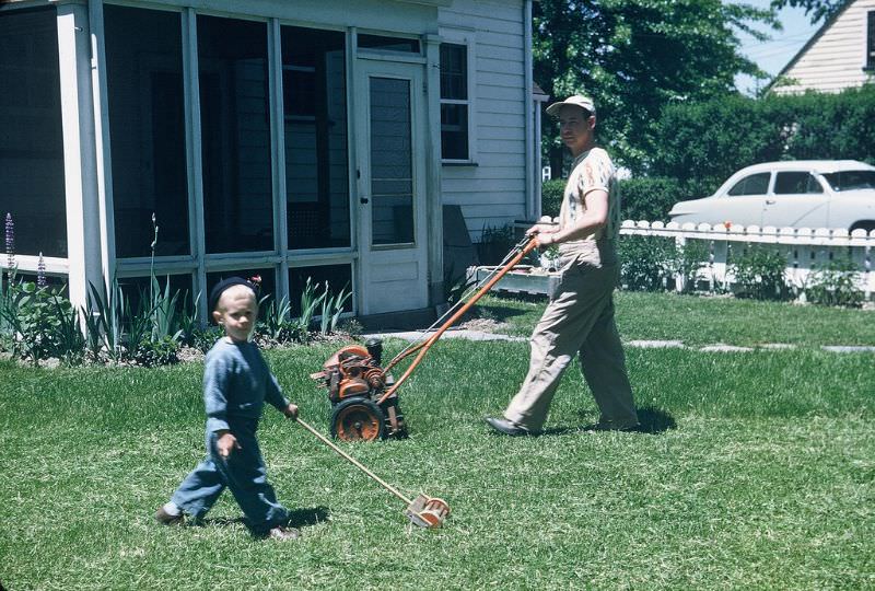 Helping dad mow the lawn, Ohio. May 1951