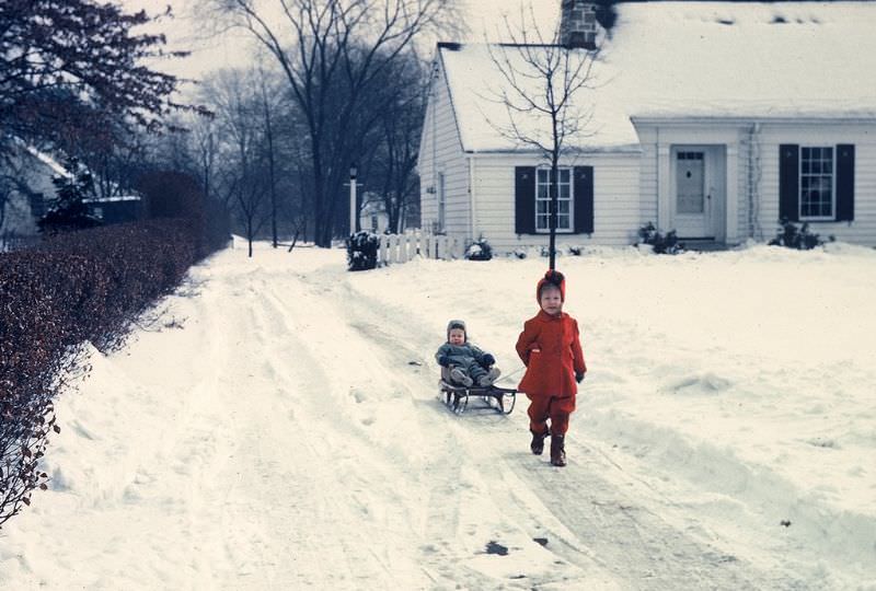 Playing in the snow in the driveway, Ohio. December 1951