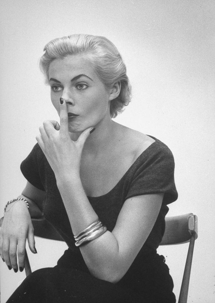 Miss Sweden Anita Ekberg practicing the nose tilt for "Fish look" that Ford Model Agency head Eileen Ford suggested she must acquire to be a successful model in the US.