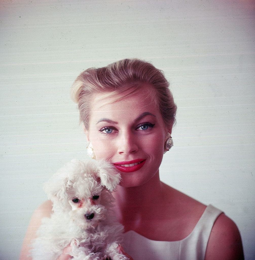 Anita Ekberg holding small dog, 1955.