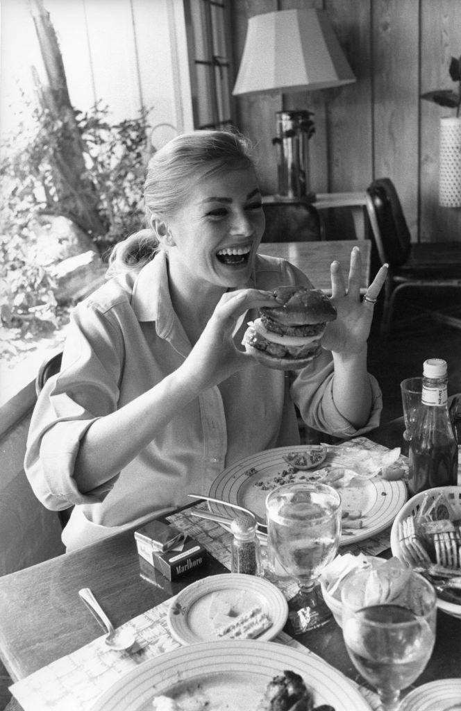 Anita Ekberg eating a hamburger, 1956.