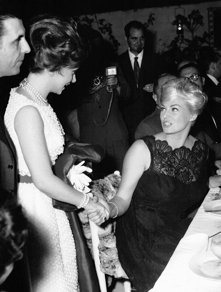 Gina Lollobrigida saying hello to Anita Ekberg at a gala diner on July 6, 1961 in Rome, Italy.