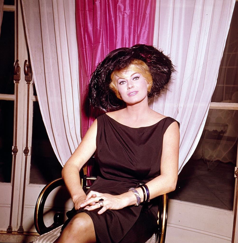 Anita Ekberg posed sitting on a chair in London in 1963.