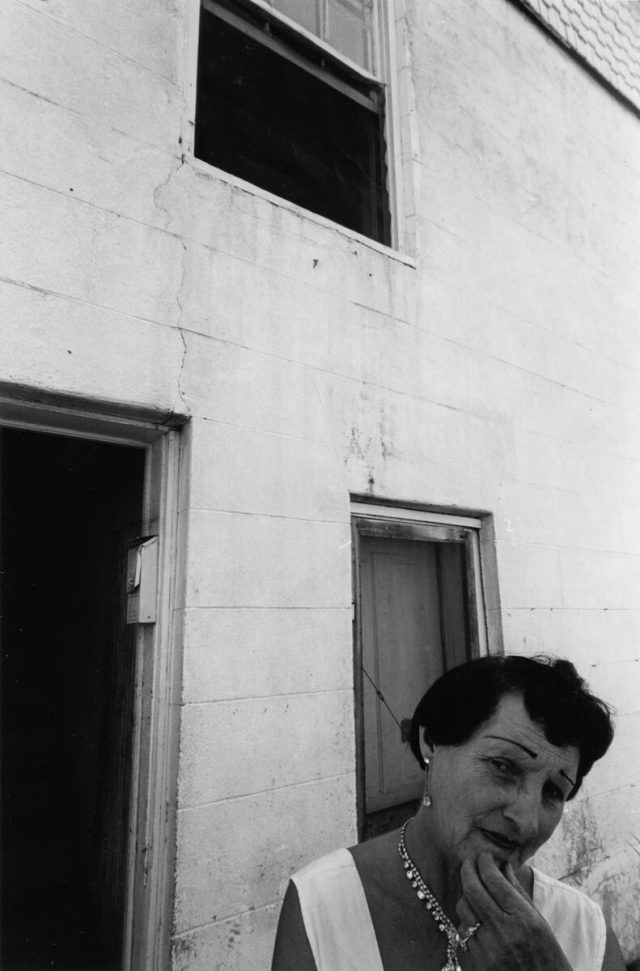 Prostitute standing in doorway of her house, 1965