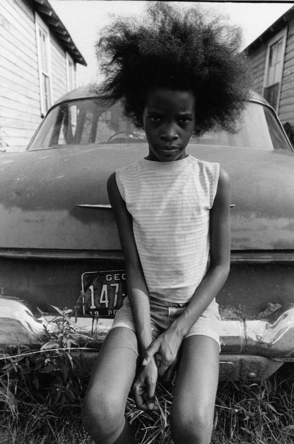 Sitting on bumper of old car, 1970