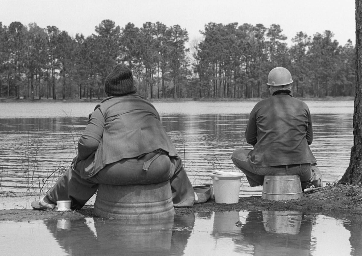 Couple fishing on tubs, Flint River, 1980 Apr