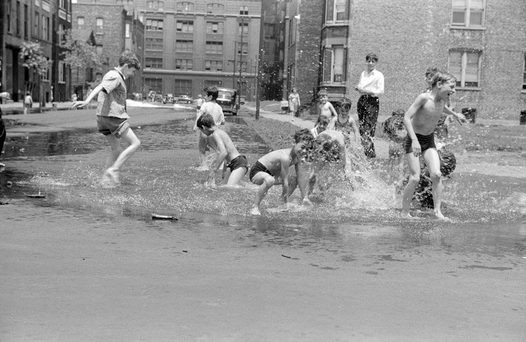 Children playing in water from hydant. Chicago 1914.