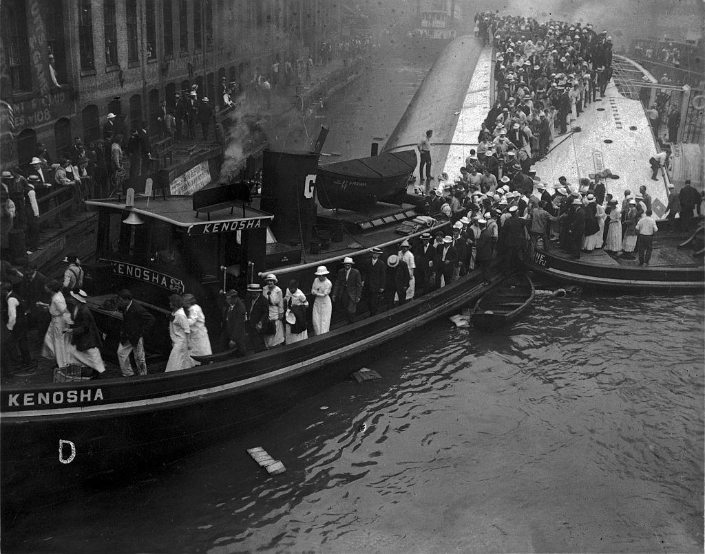 Survivors of the Eastland being lead ashore by the tugboat Kenosha. Chicago, 1915.