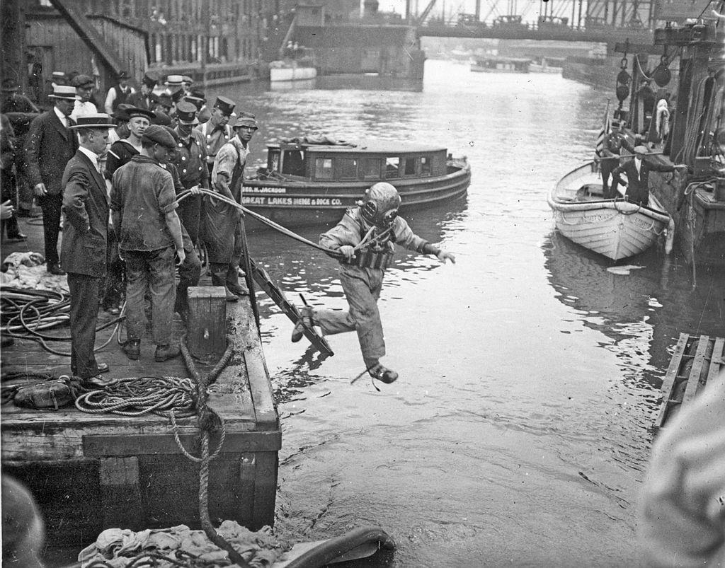 A rescue worker, dressed in a diving suit, leaps into the Chicago River at the site of the Eastland disaster, July 24, 1915.