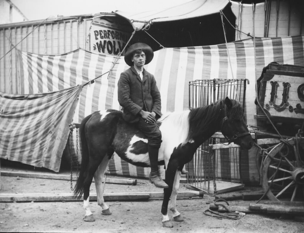 Man on a horse outside a circus, 1910.