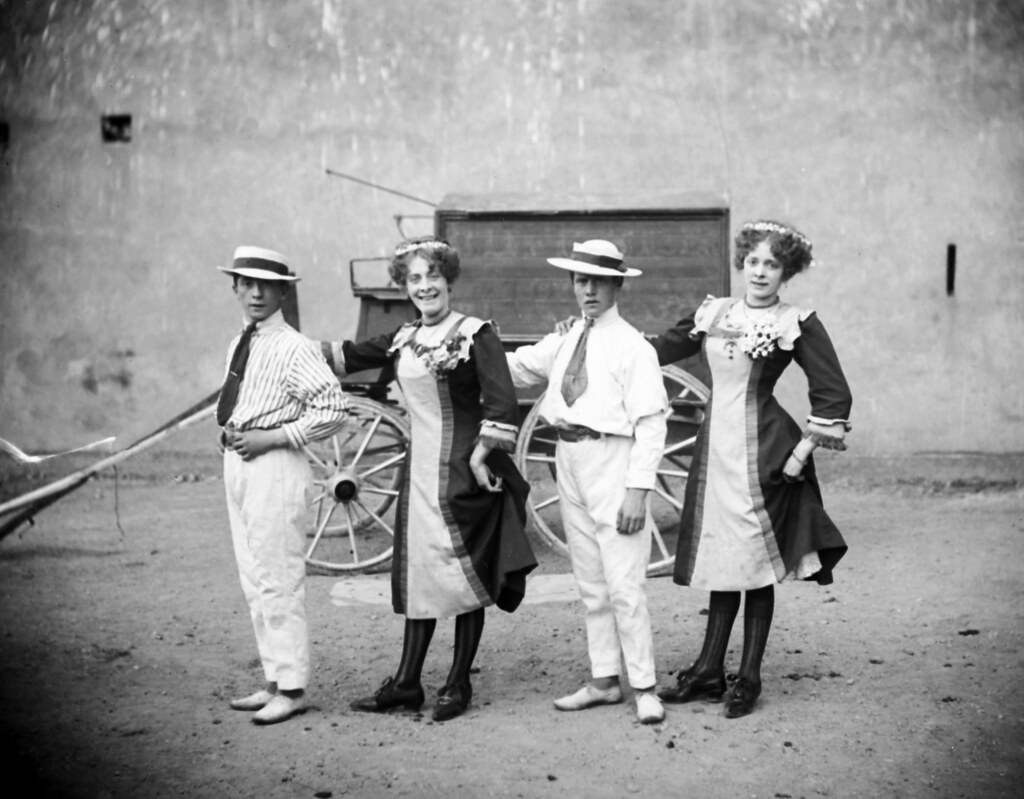 Four circus performers in front of a wagon, 1910.