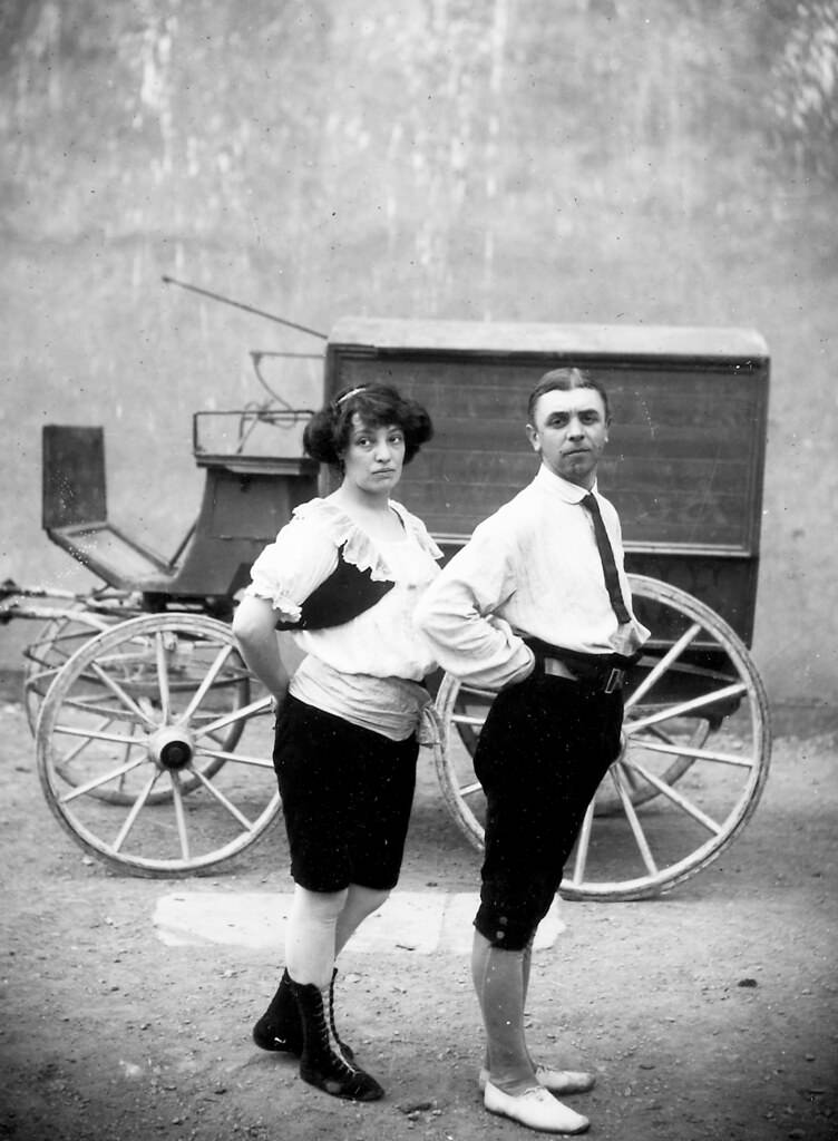 Two circus performers in front of a wagon , 1910.
