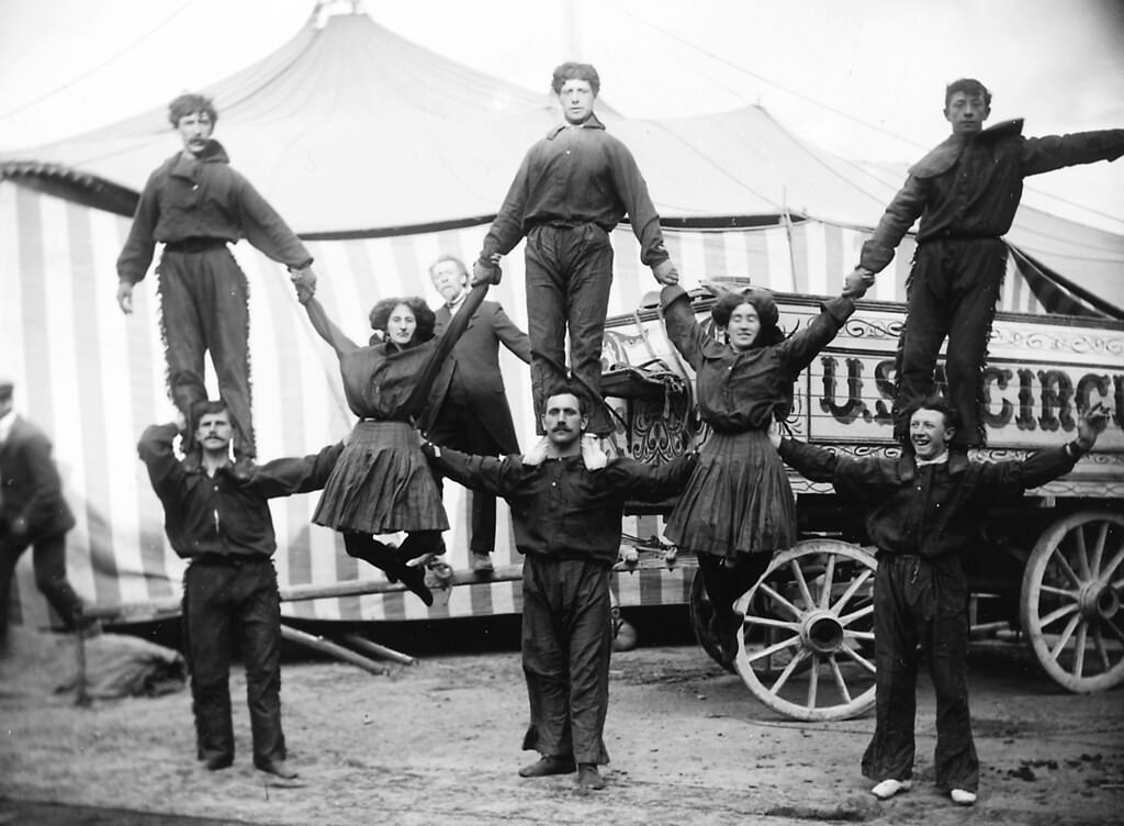 Group of circus performers standing on each other's shoulders, 1910.
