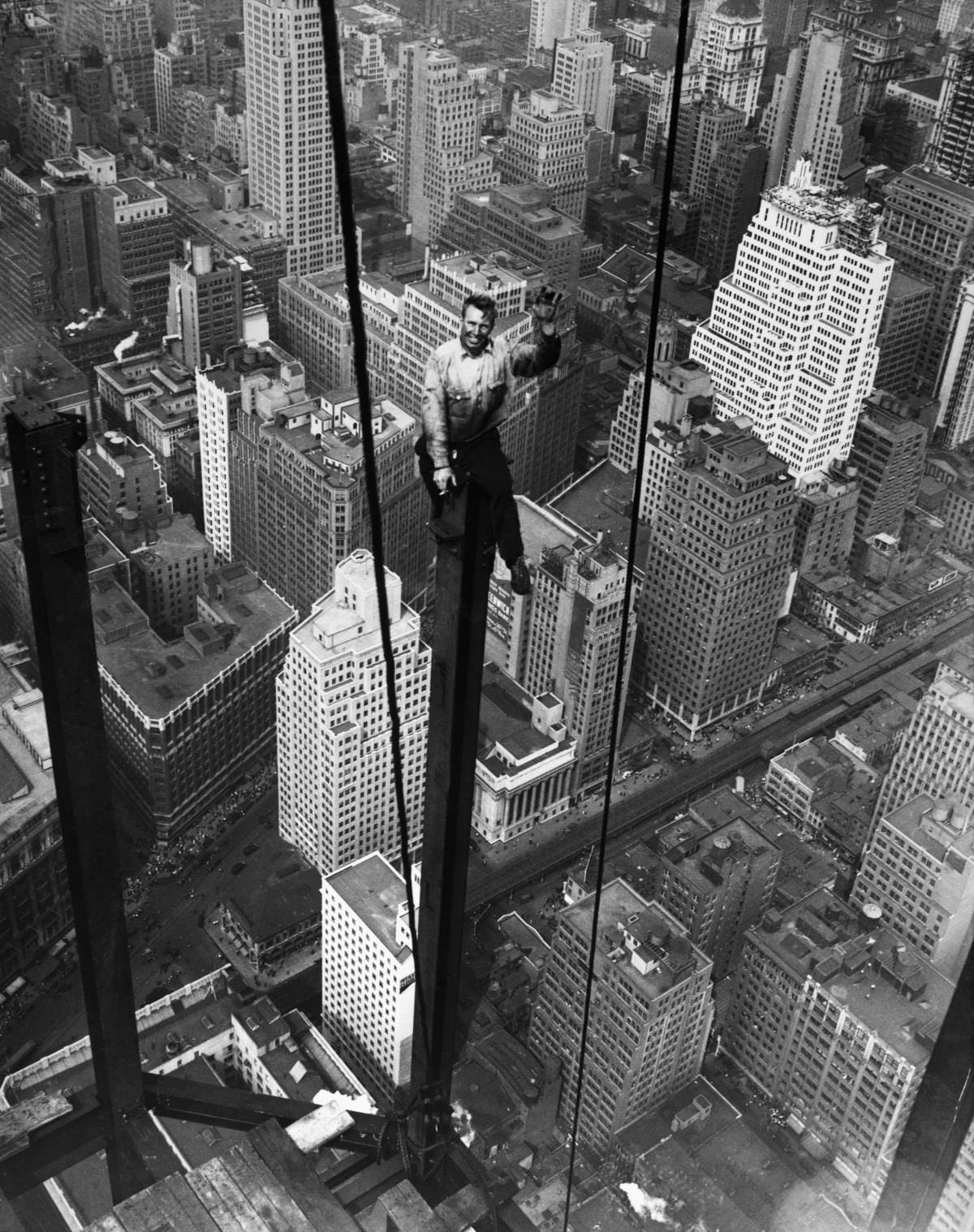 Carl Russell waves to his co-workers on the structural work of the 88th floor of the new Empire State Building.