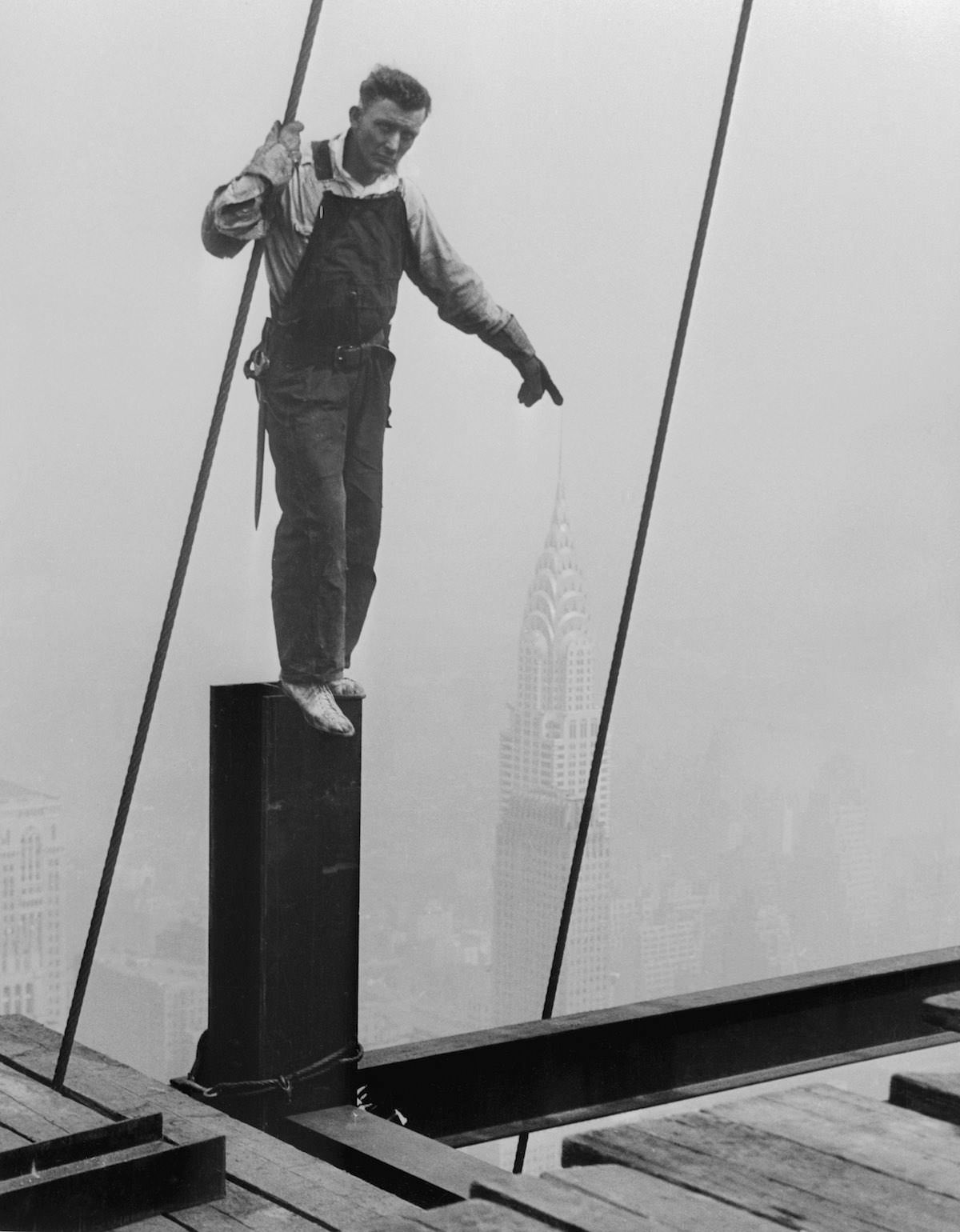 An odd photographic trick placed this steelworker's finger on the lofty pinnacle of the Chrysler Building.