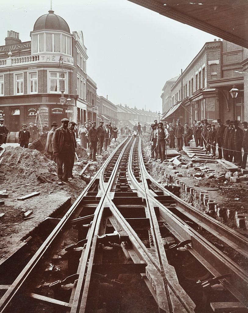 Men working on tramline electricification, Wandsworth, London, 1906.