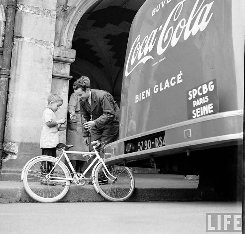 A young boy tasting Coca Cola.