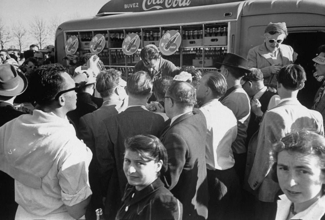 People buying Coca-Cola at an air exhibition.