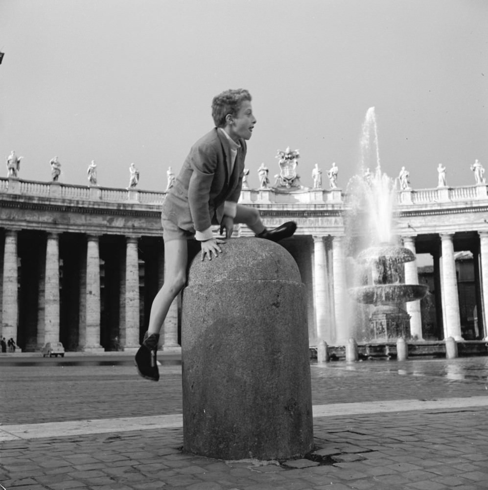 A boy plays leap-frog in St Peter's Square in The Vatican City, circa 1955.