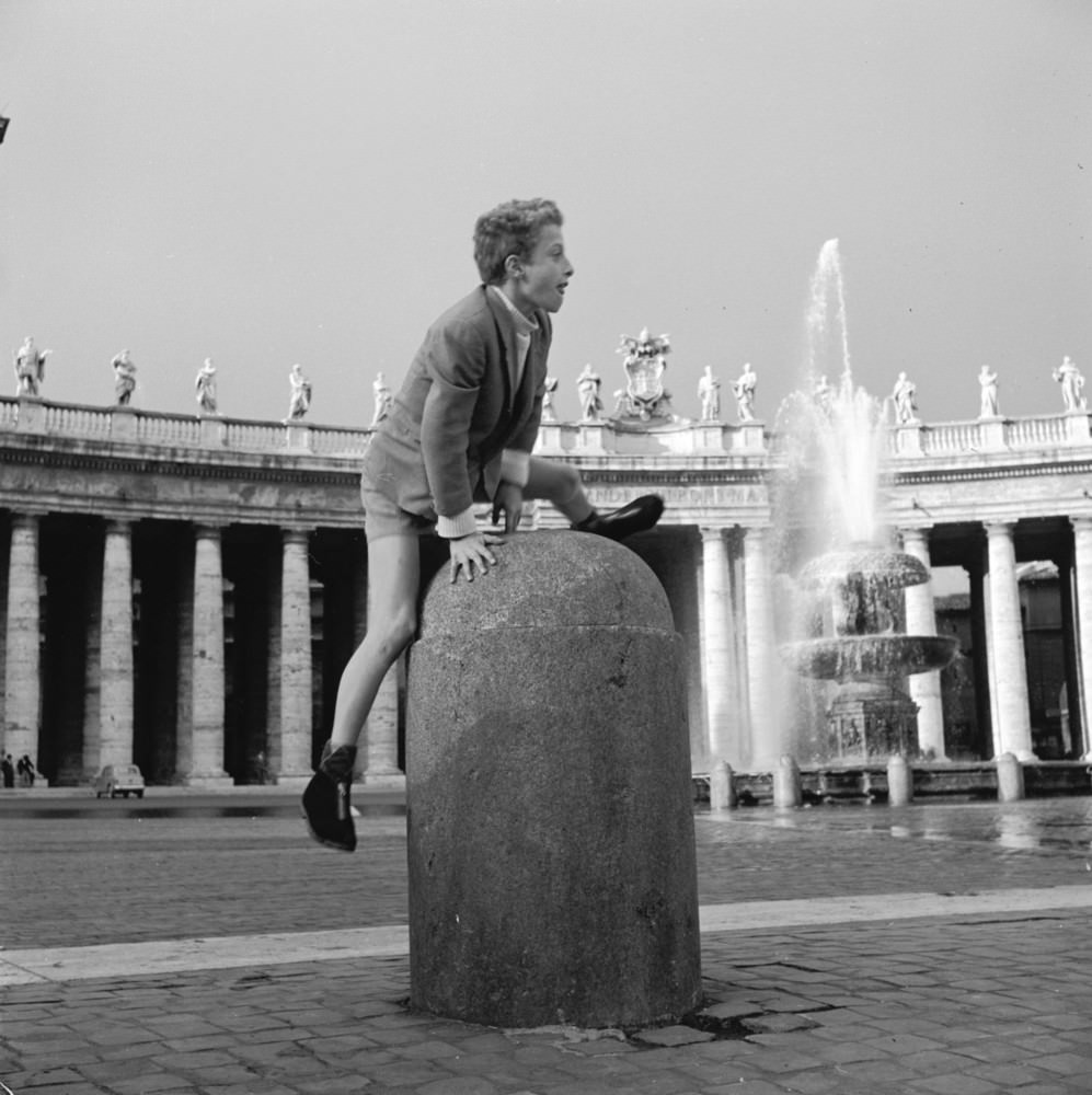 A boy plays leap-frog in St Peter's Square in The Vatican City, circa 1955.