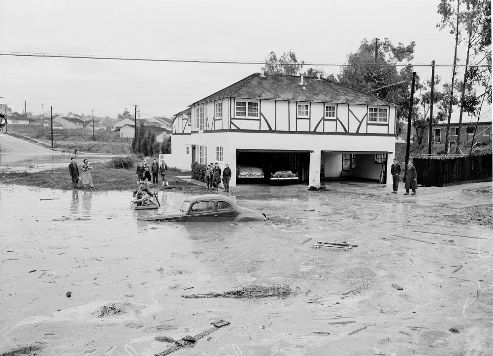 People in a boat near a drowned car in Van Nuys. 15 November 1952.