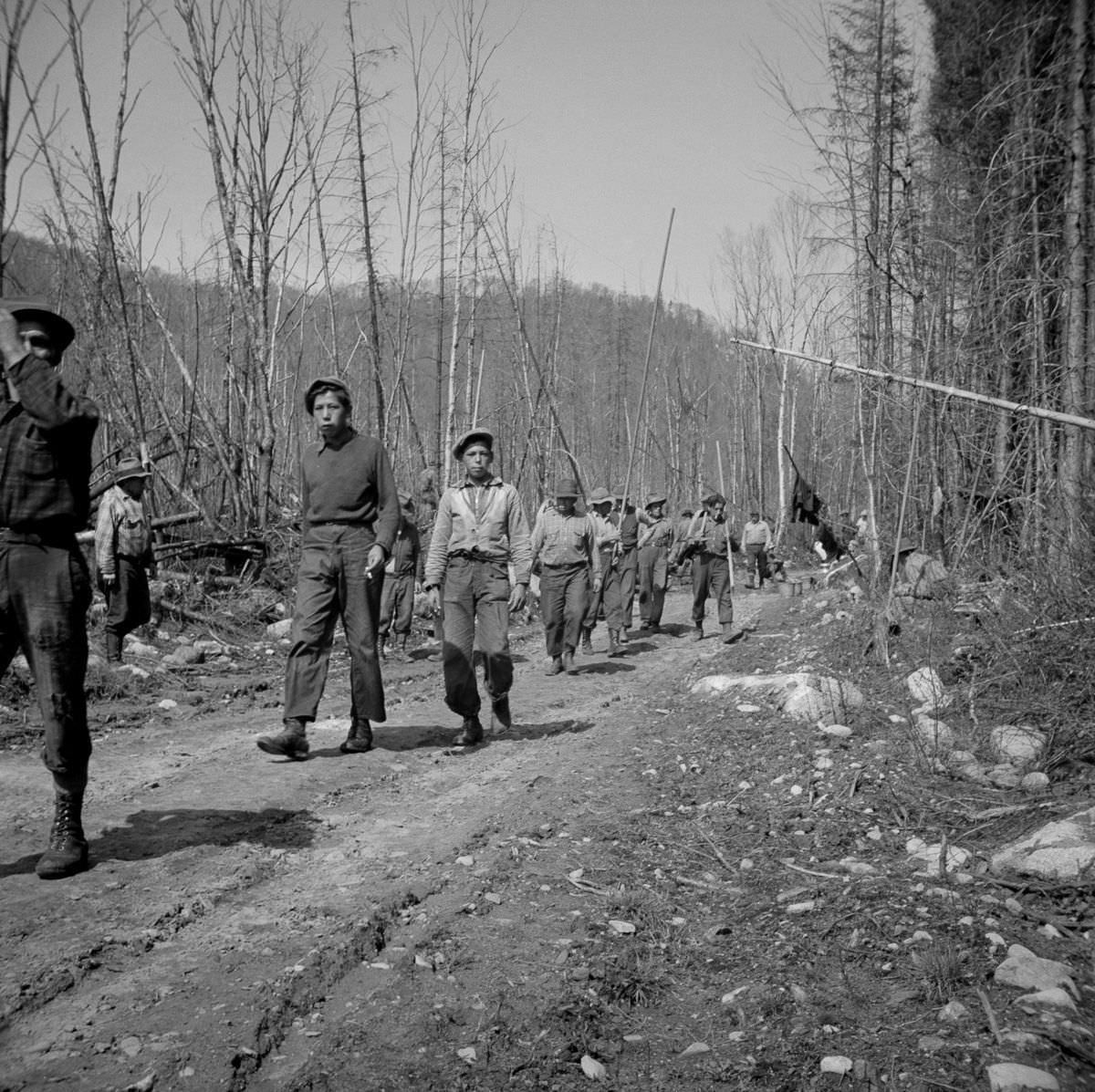 Woodsmen return to work after a lunch break.