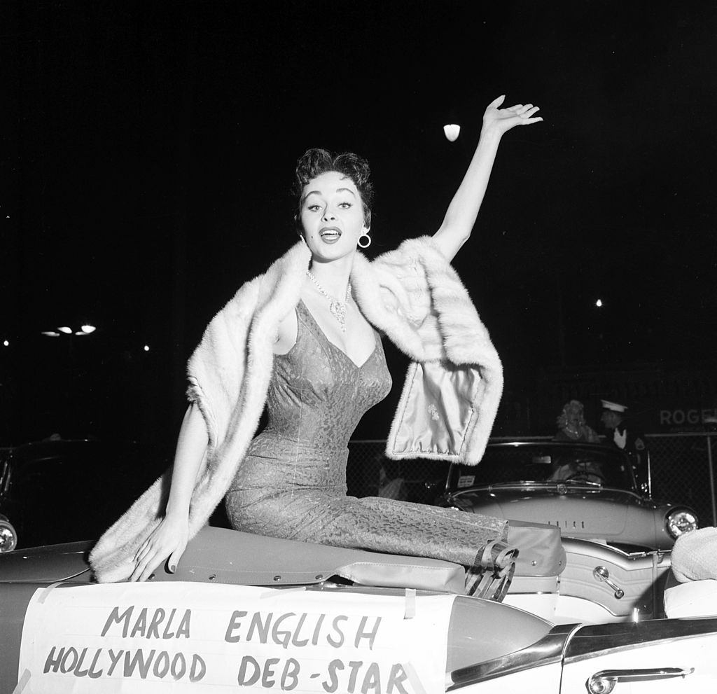 Marla English waves as the Hollywood Deb-Star in Los Angeles, 1955.