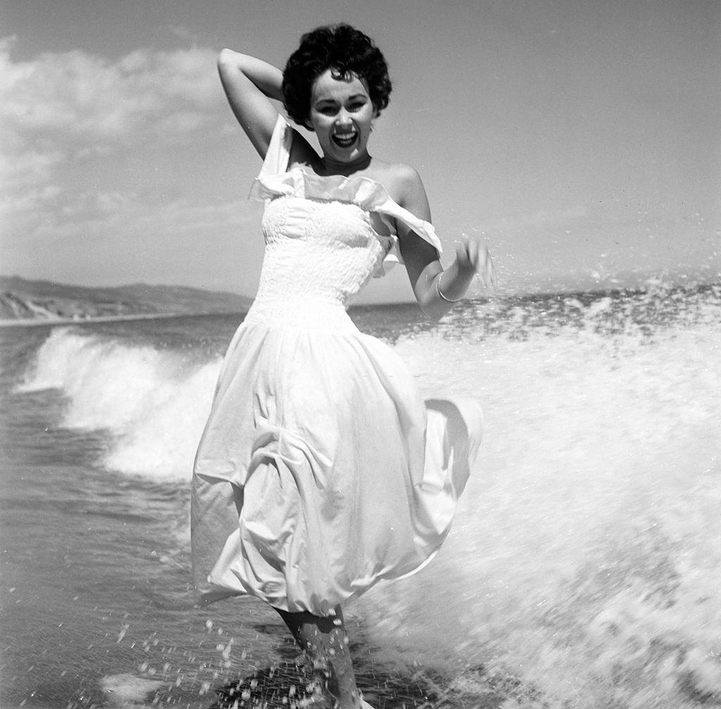 Marla English enjoying on the beach, 1954.