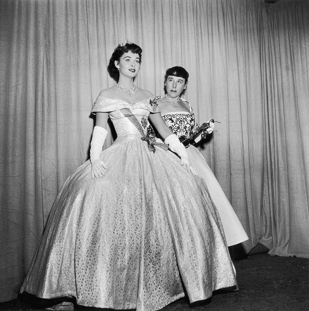 Marla English wearing a ball gown with costume designer, Edith Head, 1954.