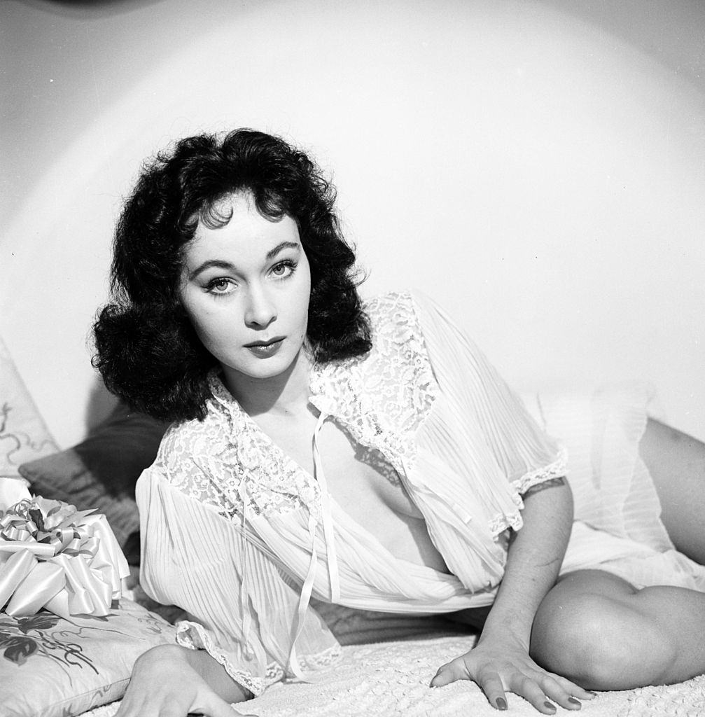 Marla English relaxing in her room, 1954.