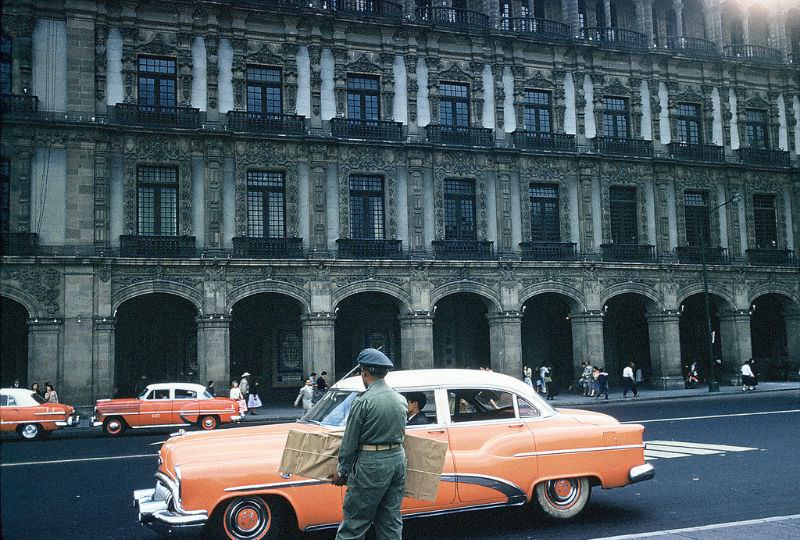 Taxis and department store, Zocalo, Mexico City. December 1958
