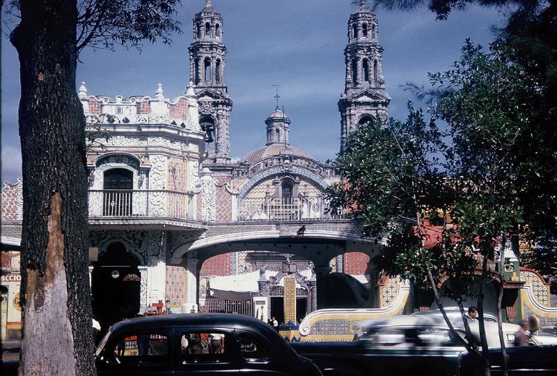 Tile-fronted buildings and church, Puebla. December 1958