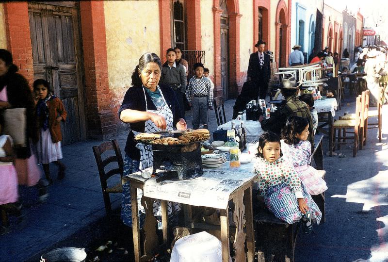Woman cooking tortillas at Festival of Guadalupe, Saltillo. December 1958