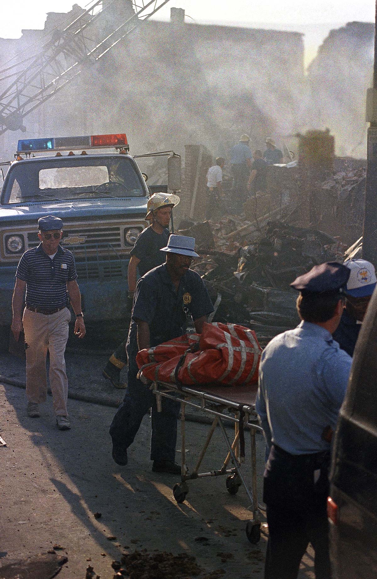 Workers remove the remains of a body from the rubble. May 14, 1985