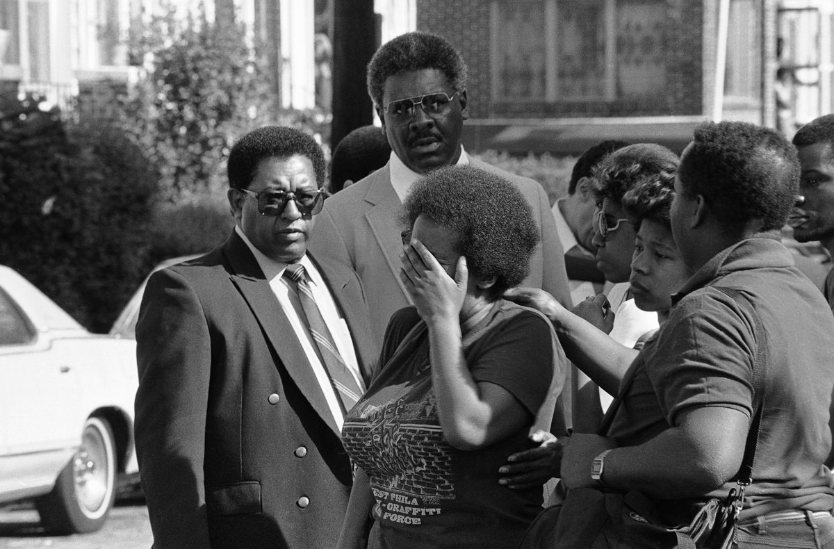 A woman mourns after returning to her destroyed neighborhood. May 15, 1985