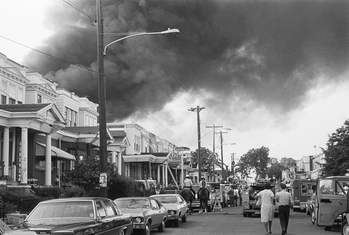 Smoke billows from the spreading fire after the bombing. May 13, 1985