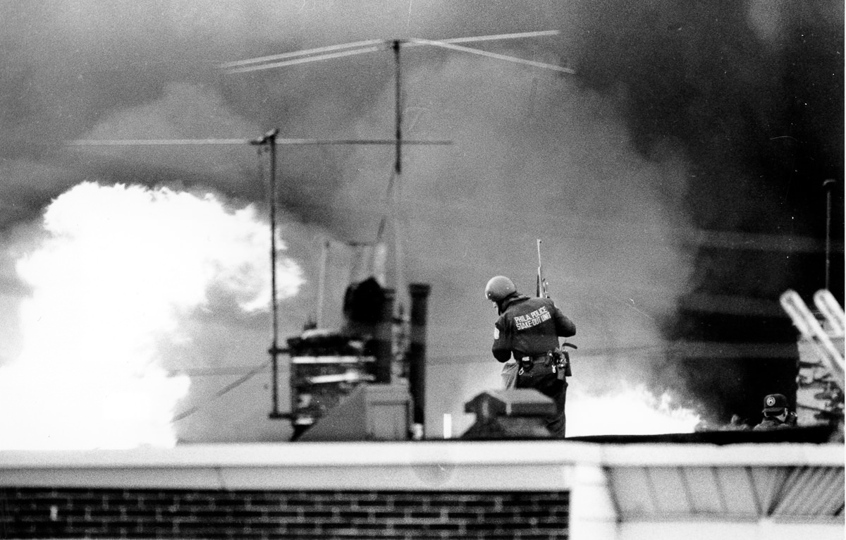 A police officer looks on as the blaze spreads. May 13, 1985