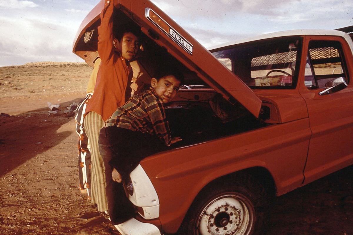 Navajo children examine their family truck in Red Rock, Arizona.