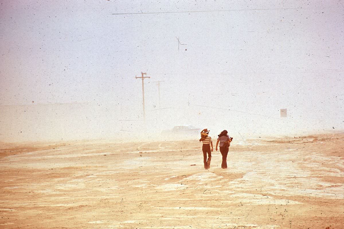 Men walk through a dust storm in Shiprock, New Mexico.