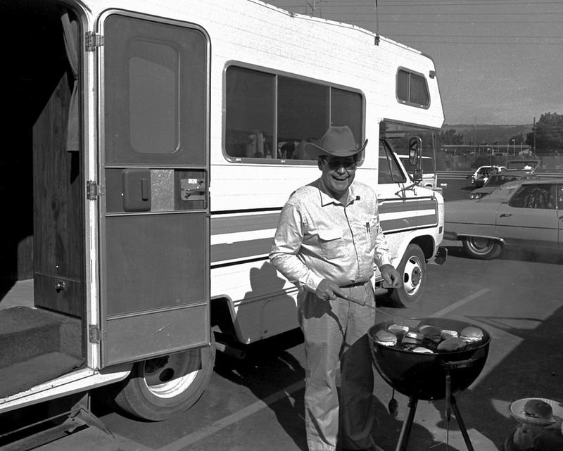 Cooking BBQ in the Coliseum parking before an Oakland Raiders football game, Oakland, 1980.